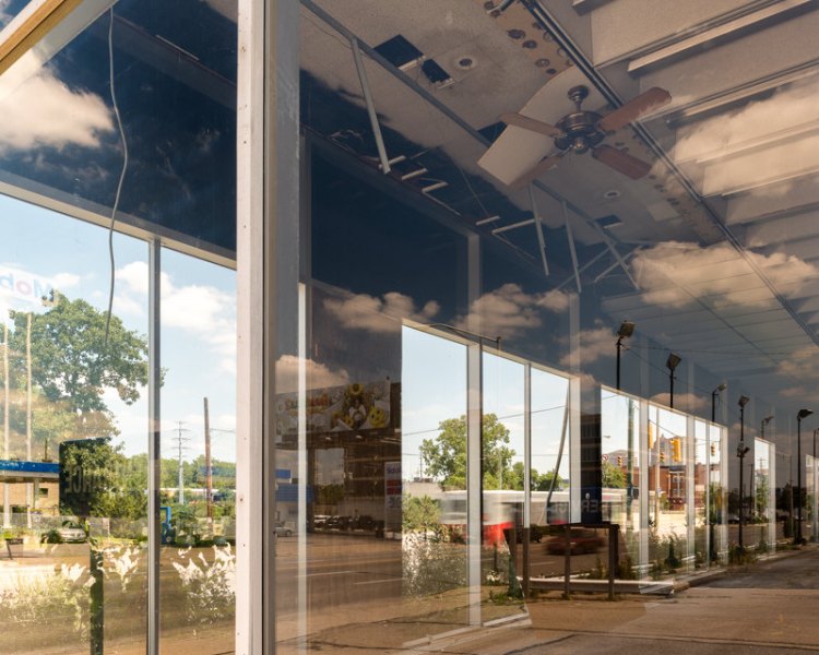 Vacant Dealership and Sky Reflections